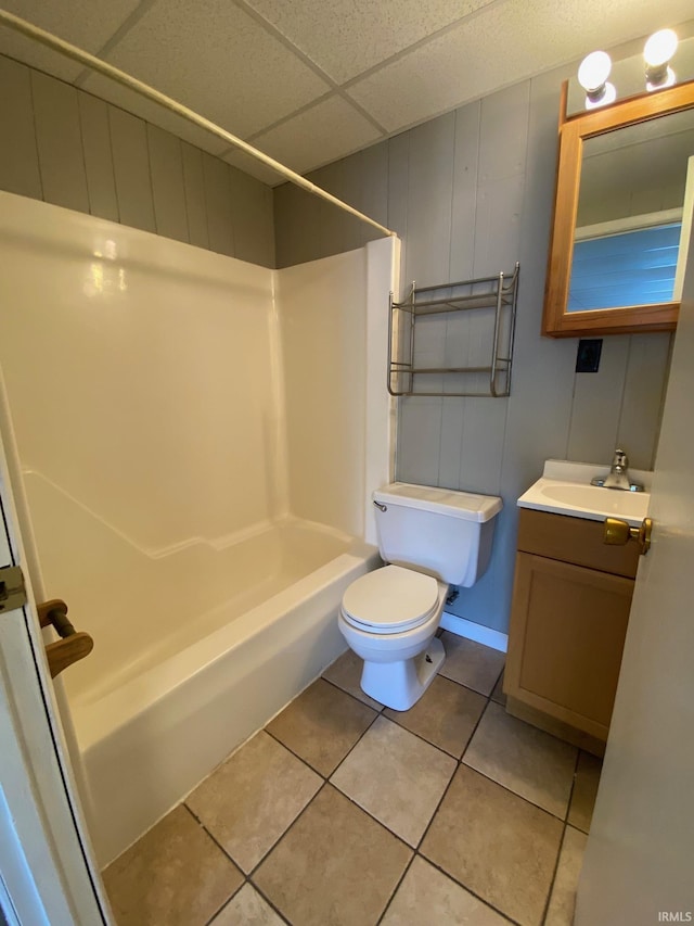 full bathroom featuring tile patterned floors, toilet, a paneled ceiling,  shower combination, and vanity