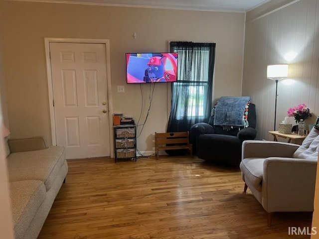 living room featuring ornamental molding and hardwood / wood-style floors