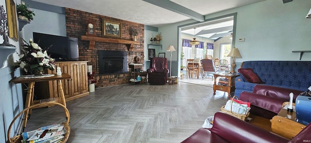 living area with a brick fireplace and beam ceiling