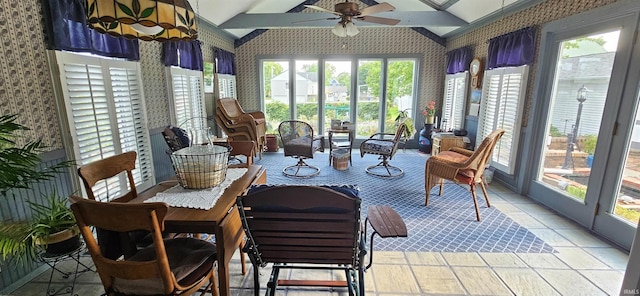 sunroom / solarium featuring lofted ceiling and wallpapered walls