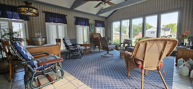 sunroom featuring carpet floors, vaulted ceiling, wallpapered walls, and a healthy amount of sunlight