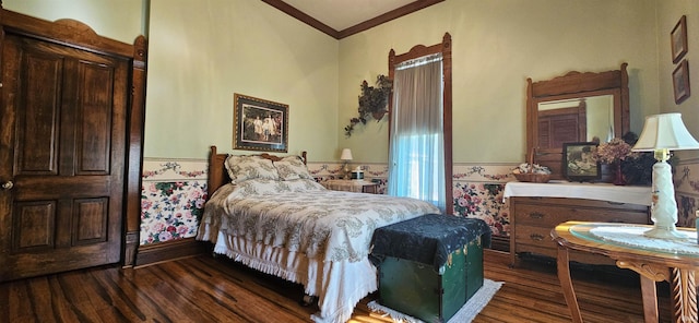 bedroom with dark wood-type flooring, ornamental molding, and a wainscoted wall