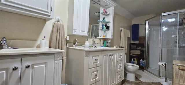 full bathroom featuring toilet, a stall shower, and vanity