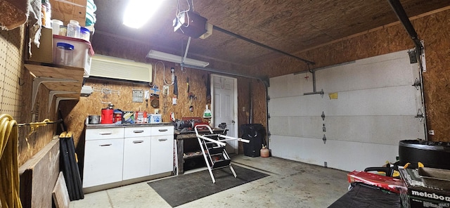 garage with a workshop area and a garage door opener