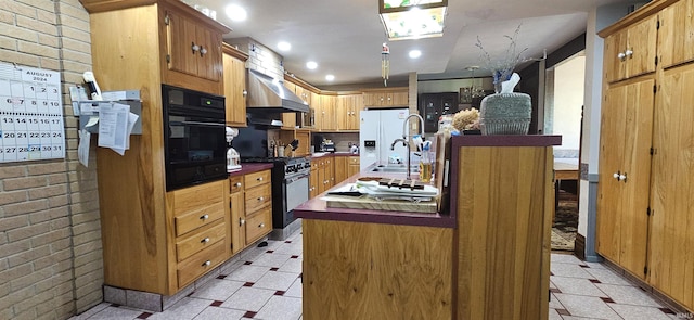 kitchen with ventilation hood, stainless steel gas range, dark countertops, and black oven