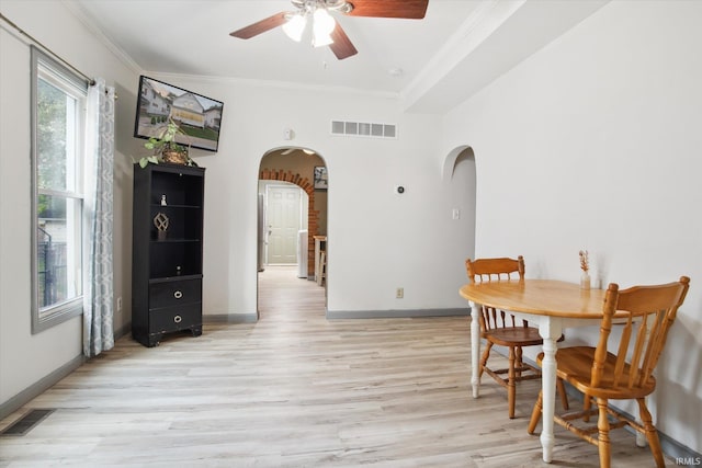 dining room featuring light wood-type flooring, ceiling fan, and ornamental molding