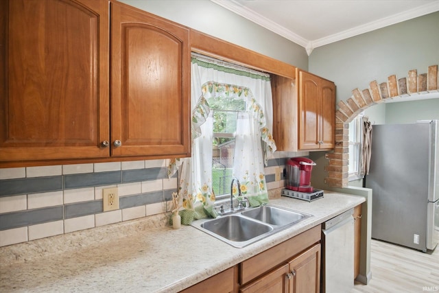 kitchen with sink, decorative backsplash, stainless steel fridge, and white dishwasher