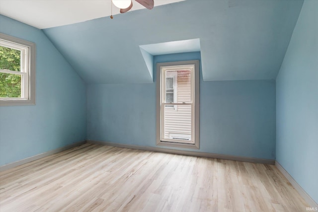 additional living space with lofted ceiling, light wood-type flooring, and ceiling fan