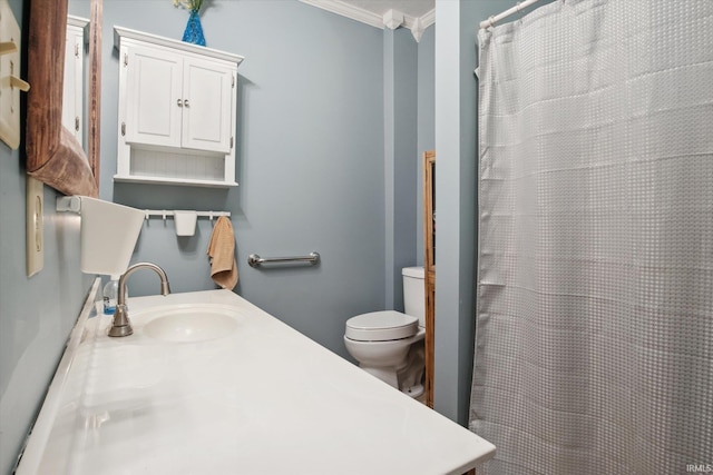 bathroom featuring crown molding, toilet, and vanity