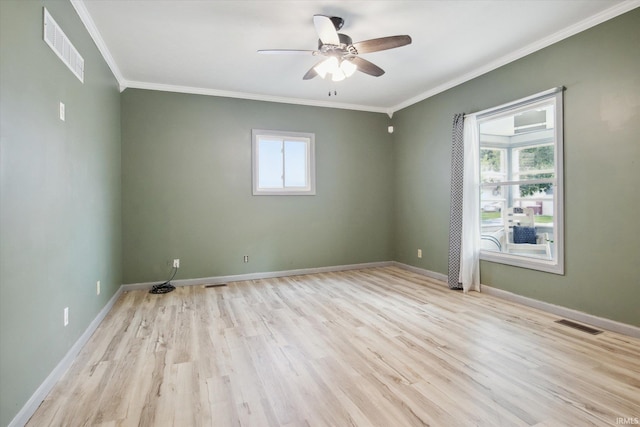 unfurnished room featuring a healthy amount of sunlight, light hardwood / wood-style flooring, and ornamental molding