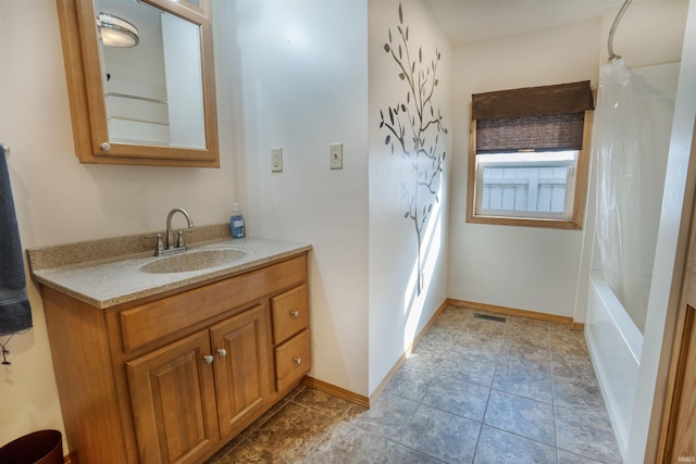 bathroom featuring vanity, shower / bathtub combination with curtain, and tile patterned flooring