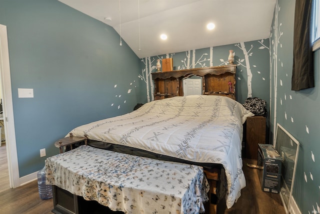 bedroom with lofted ceiling and dark hardwood / wood-style floors