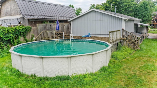 view of pool with a yard