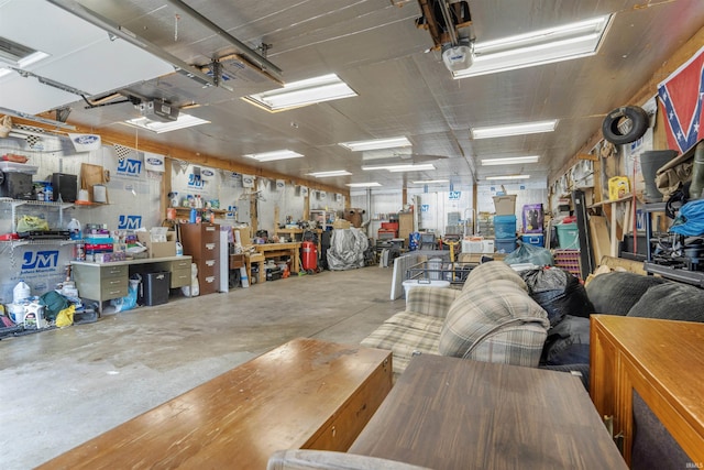 garage with a garage door opener and a workshop area