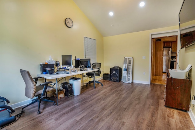 home office featuring high vaulted ceiling and hardwood / wood-style floors