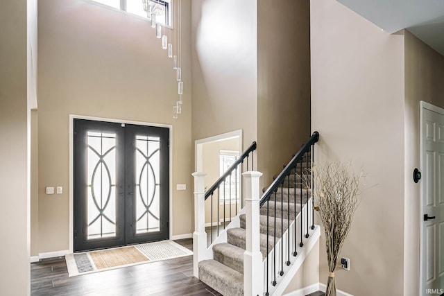 foyer entrance featuring plenty of natural light, french doors, and wood-type flooring