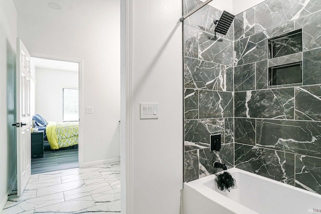 bathroom featuring tile patterned floors and tiled shower / bath combo