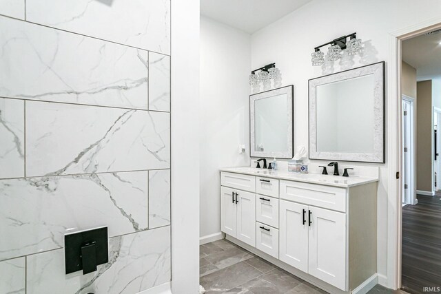 bathroom with dual vanity and hardwood / wood-style floors