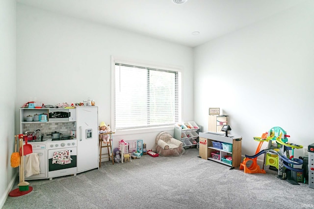 game room featuring light carpet