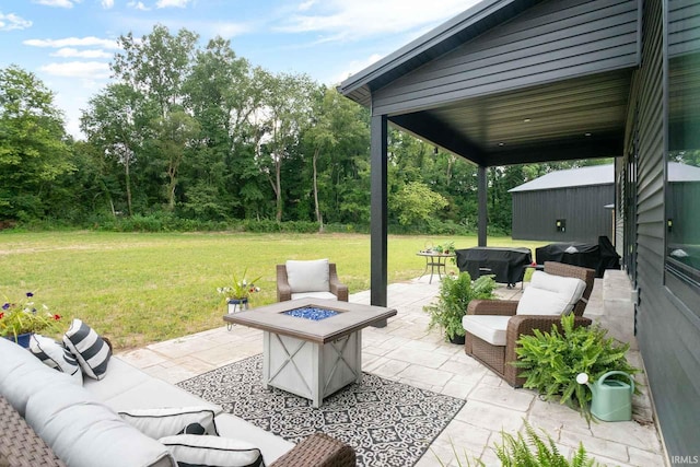 view of patio featuring area for grilling and an outdoor living space with a fire pit