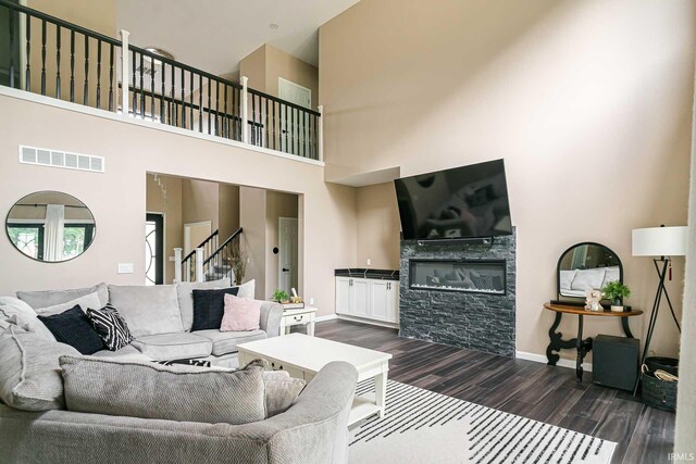 living room featuring dark hardwood / wood-style flooring and a high ceiling