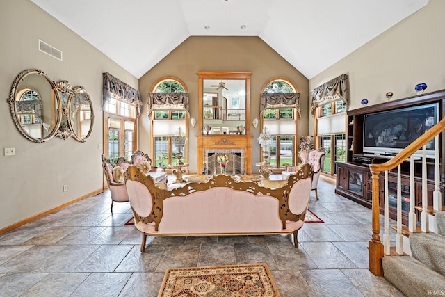 living room with high vaulted ceiling, tile patterned floors, ceiling fan, and plenty of natural light