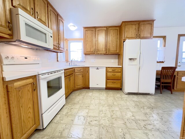 kitchen featuring white appliances and sink