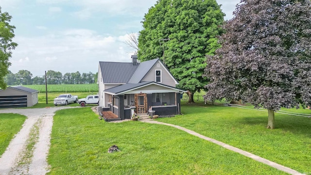 view of front facade with a sunroom and a front lawn