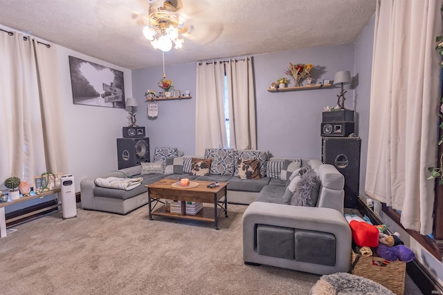 living room with a textured ceiling, ceiling fan, and carpet flooring