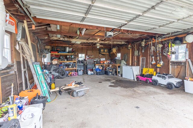 garage with a workshop area and a garage door opener