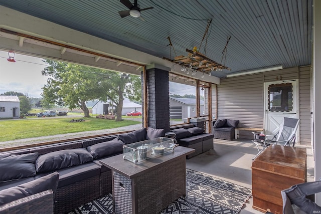 view of patio with an outdoor living space and ceiling fan