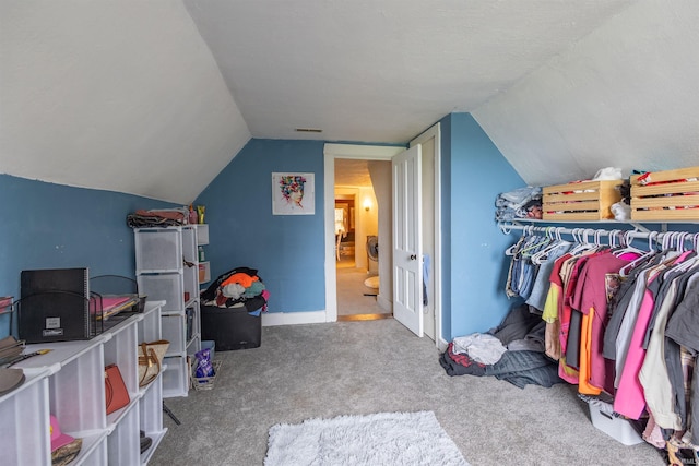 interior space featuring carpet floors and vaulted ceiling