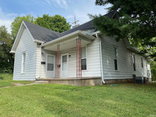 435 16th St, Bedford, IN 47421 - view of front of home with central air condition unit, a front yard, a porch, and roof with shingles
