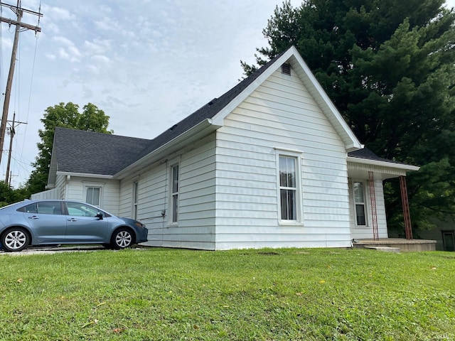 view of side of property with a lawn