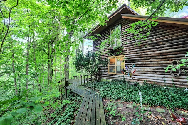 view of side of property featuring a wooden deck