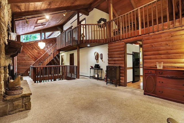 interior space featuring beam ceiling, wood ceiling, rail lighting, and high vaulted ceiling