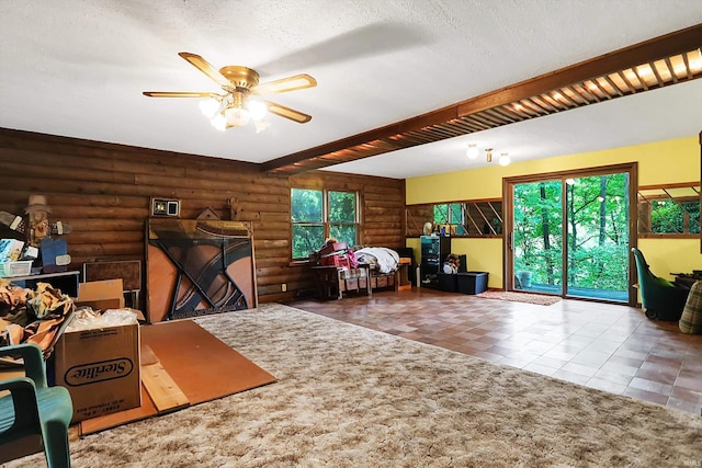 interior space featuring a textured ceiling, ceiling fan, and tile patterned flooring