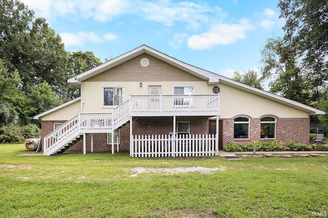 back of house with a yard and a wooden deck