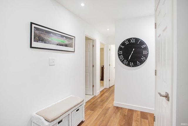 corridor with light hardwood / wood-style floors