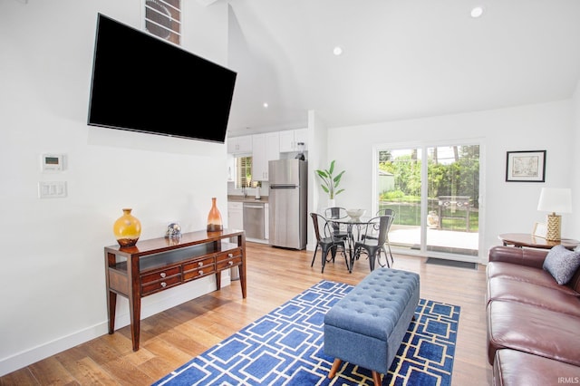 living room with sink and light hardwood / wood-style floors