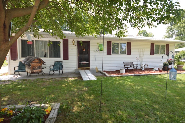 view of front facade with a patio and a front yard