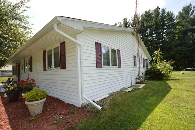 view of property exterior featuring a lawn