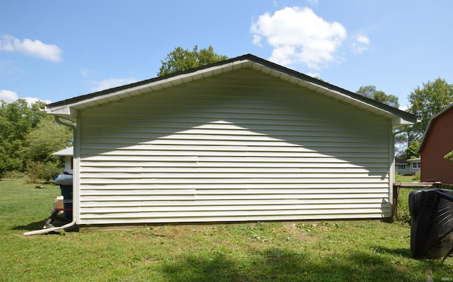 view of side of property with a yard