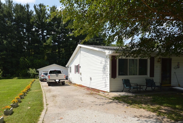 view of side of property with a yard and a garage