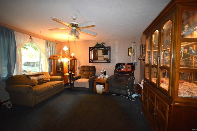 living room featuring dark colored carpet and ceiling fan