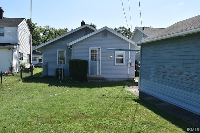 back of property with a lawn