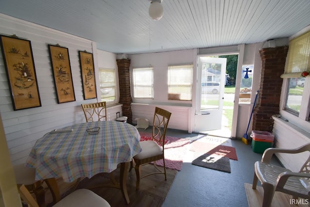 dining room with a wealth of natural light and brick wall