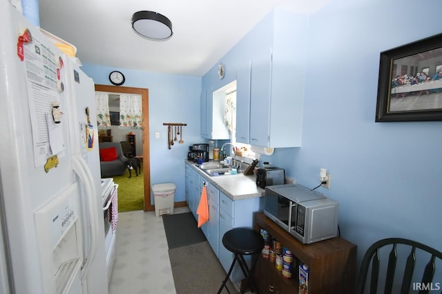 kitchen with light carpet, stove, white refrigerator with ice dispenser, washer / clothes dryer, and sink