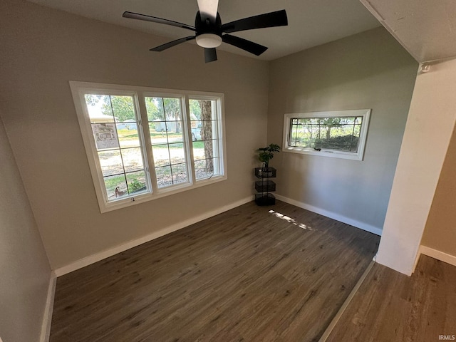 spare room with dark wood-type flooring and ceiling fan