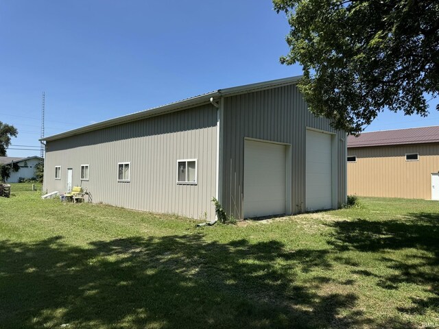 exterior space with a garage and a yard